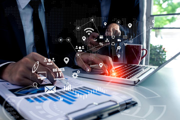 Double exposure of business people hands with laptop and digital stock market graph background.	