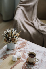 Coffee cup with flowers. Stylish flat lay. Home decoration. Cozy warm image, hygge style