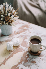 Coffee cup with flowers. Stylish flat lay. Home decoration. Cozy warm image, hygge style