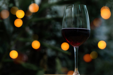 Soft focus red wine in glass on the bar, and hands of a bartender at bar with glass whiskey drink