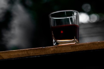 whisky shot glass at bar counter.	