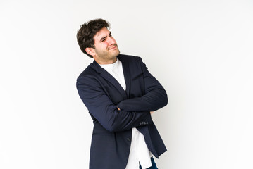 Young business man isolated on white background dreaming of achieving goals and purposes