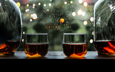 a glass of whiskey on wood bar, soft focus.	