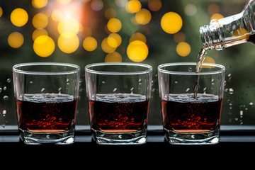 a glass of whiskey on wood bar, soft focus.	