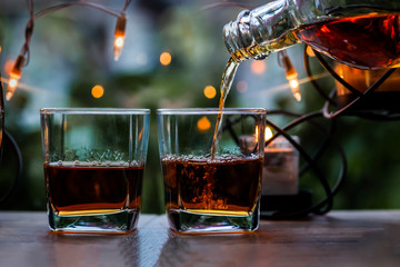a glass of whiskey on wood bar, soft focus.	