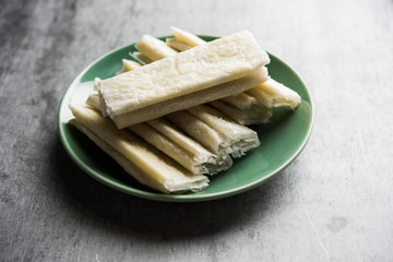 Pootharekulu  is a popular recipe originated from Andhra Pradesh, India.It is a paper-thin sweet or dessert made from rice start/gram flour, jaggery/sugar and clarified butter. Served in a plate.