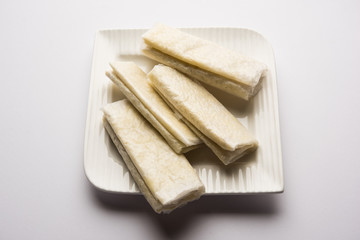 Pootharekulu  is a popular recipe originated from Andhra Pradesh, India.It is a paper-thin sweet or dessert made from rice start/gram flour, jaggery/sugar and clarified butter. Served in a plate.