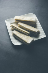 Pootharekulu  is a popular recipe originated from Andhra Pradesh, India.It is a paper-thin sweet or dessert made from rice start/gram flour, jaggery/sugar and clarified butter. Served in a plate.