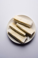 Pootharekulu  is a popular recipe originated from Andhra Pradesh, India.It is a paper-thin sweet or dessert made from rice start/gram flour, jaggery/sugar and clarified butter. Served in a plate.