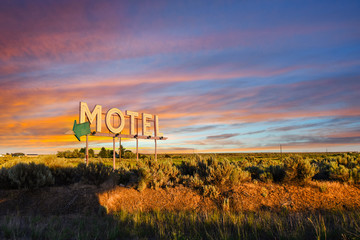 Vintage roadside highway Motel advertising sign seen through a colorful sunset in the American...