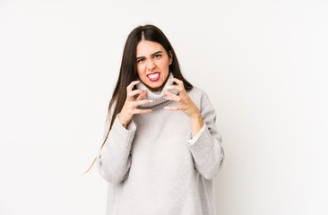 Young caucasian woman isolated on a white background upset screaming with tense hands.