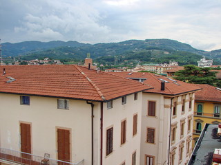 Top view of an ancient italian town on a background of mountain ranges on the horizon at sunset.