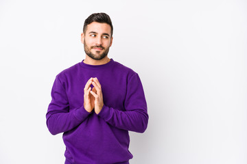 Fototapeta premium Young caucasian man against a white background isolated making up plan in mind, setting up an idea.