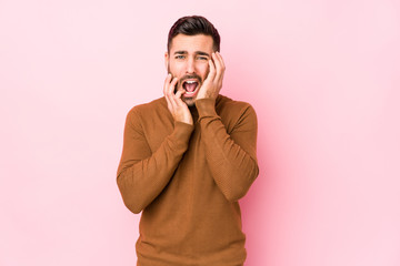 Young caucasian man against a pink background isolated whining and crying disconsolately.