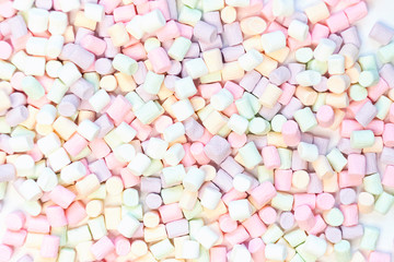 Top View of Pastel Shaped Marshmallow Candies with Some Scattered on the Pale white Table