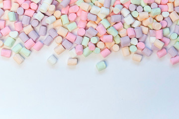 Top View of Pastel Shaped Marshmallow Candies with Some Scattered on the Pale white Table