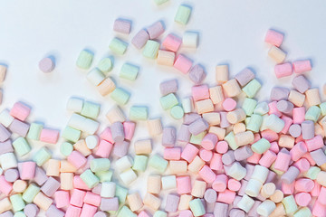 Top View of Pastel Shaped Marshmallow Candies with Some Scattered on the Pale white Table