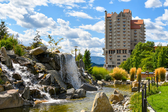 A landscaped waterfall and pond in the public McEuen Park near the resort in the lakeside town of Coeur d'Alene Idaho USA
