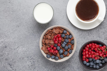 Chocolate corn flakes in a bowl with milk and berries. Delicious healthy Breakfast.