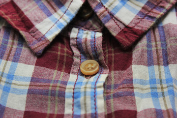 Flannel checkered shirt pattern close up top view. Casual summer shirt, plaid fabric texture,...