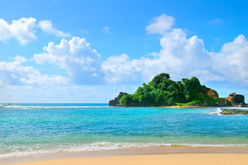 The azure waters of the tropical ocean, peninsula, palm trees and the beach.