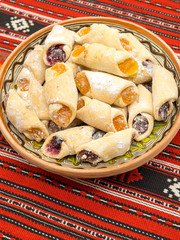 traditional romanian festive dessert dumplings filled with assorted turkish delight served on a traditional cloth