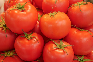 Pile red fresh tomatoes background.