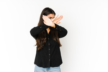Fototapeta premium Young indian woman isolated on purple background keeping two arms crossed, denial concept.