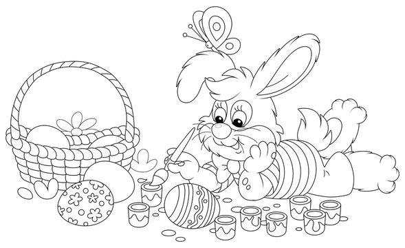 Happy little bunny painting beautiful Easter eggs with bright and colorful paints and an art paintbrush, black and white vector cartoon illustration for a coloring book