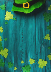 St Patrick Day dark green wooden rustic background with shamrock and leprechaun costume hat - 328570415