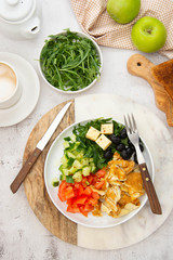 Fresh omelette for breakfast with mixed vegetables, toast brerad and cup of coffee. Top view.
