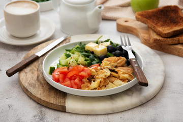 Fresh omelette for breakfast with mixed vegetables, toast brerad and cup of coffee.