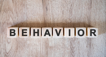 Behavior text word on wooden cubes on wooden background