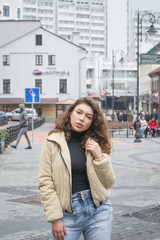 Stylish modern girl posing for a photo in the street