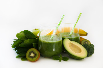 Freshly made green smoothie made of vegetables, fruits, herbs and greens. Glass of blended vegan...