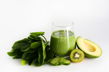 Freshly made green smoothie made of vegetables, fruits, herbs and greens. Glass of blended vegan...