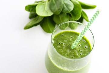 Freshly made green smoothie made of vegetables, fruits, herbs and greens. Glass of blended vegan...