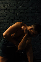 Middle aged attractive man practicing yoga concept, sitting in difficult pose, working out wearing black sportswear. Healthy lifestyle concept.