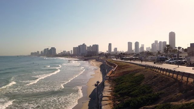 Tel Aviv-Yafo, skyline of the city with the Mediterrean Sea and Jaffa to Tel Aviv boardwalk with people, 4k video footage