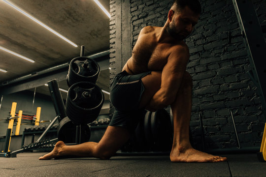 Middle Aged Attractive Man Practicing Yoga Concept, Sitting In Difficult Pose, Working Out Wearing Black Sportswear. Healthy Lifestyle Concept.