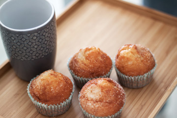 breakfast muffins and cup on table