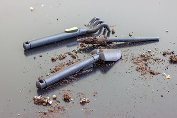 Set of mini garden tools for plant care. Shovel and rake for digging and loosening the soil..