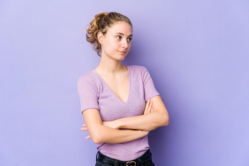 Young caucasian woman on purple background dreaming of achieving goals and purposes