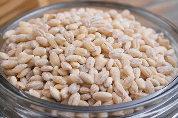 Pearl barley in a glass jar close-up