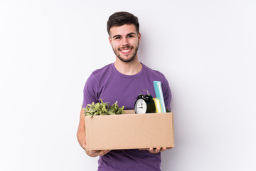 Young caucasian man moving a new home isolated happy, smiling and cheerful.