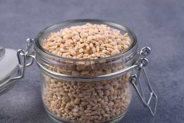 Pearl barley in a glass jar close-up