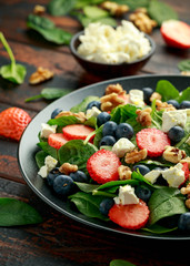 Spinach, Strawberry, blueberry salad with walnut and feta cheese. Summer healthy food