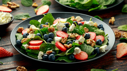 Spinach, Strawberry, blueberry salad with walnut and feta cheese. Summer healthy food