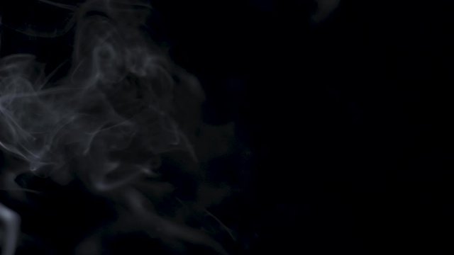 White Smoke In Slow Motion On Dark Black Background