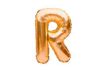 Letter R made of golden inflatable helium balloon isolated on white. Gold foil balloon font part of...